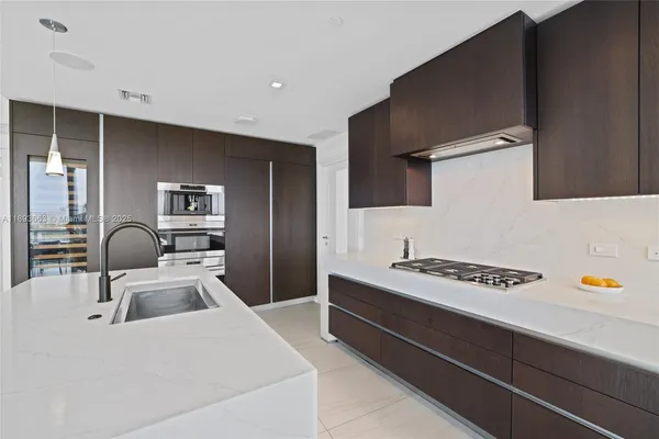 a kitchen that has a sink and a stove