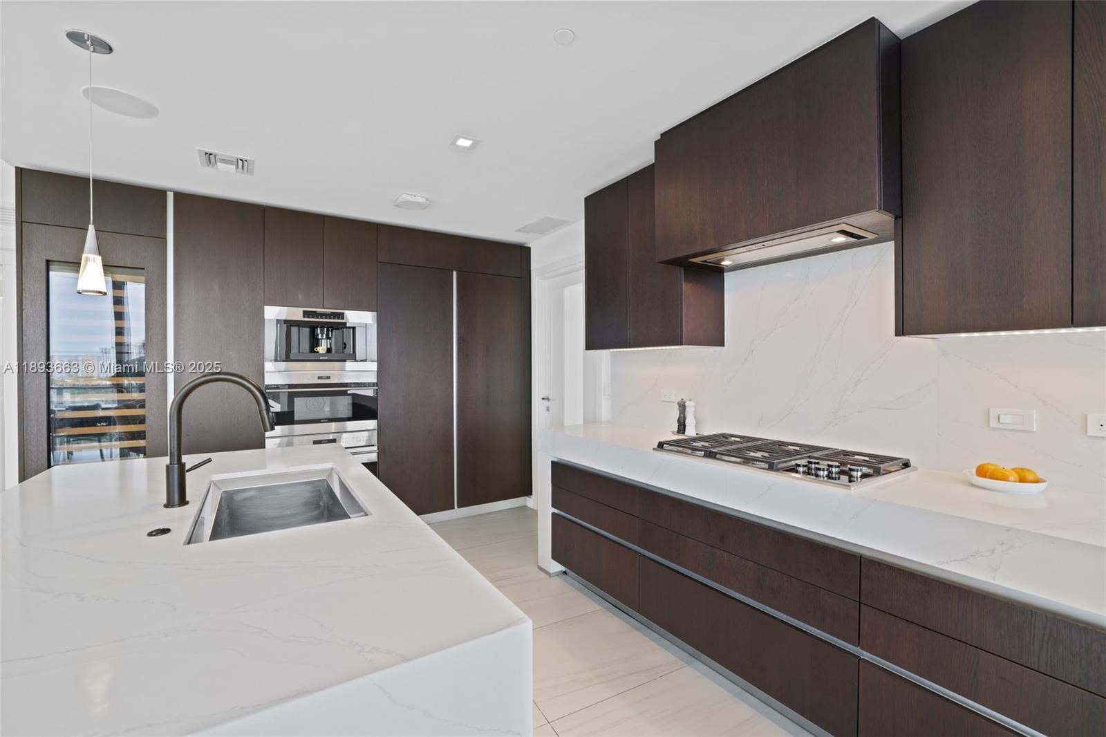 2200 North Ocean Boulevard, Unit N504 Fort Lauderdale, FL 33305 - Photo 9 of 43 a kitchen that has a sink and a stove