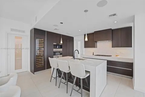 a kitchen with stainless steel appliances a stove a sink refrigerator and cabinets