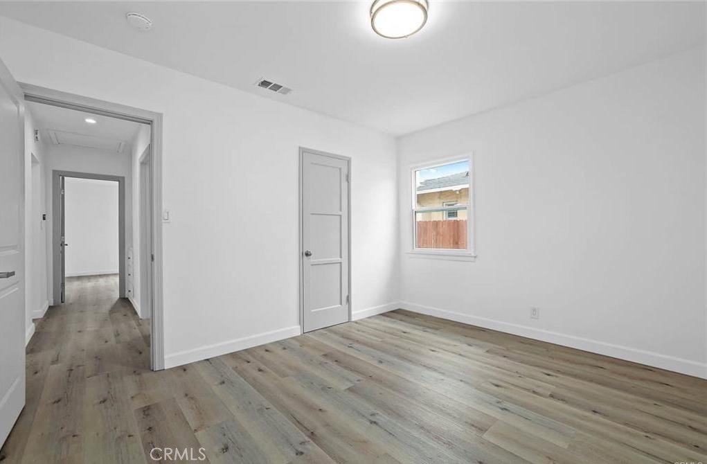 100 Eastern Pasadena, CA 91107 - Photo 15 of 18 a view of an empty room with wooden floor and a window