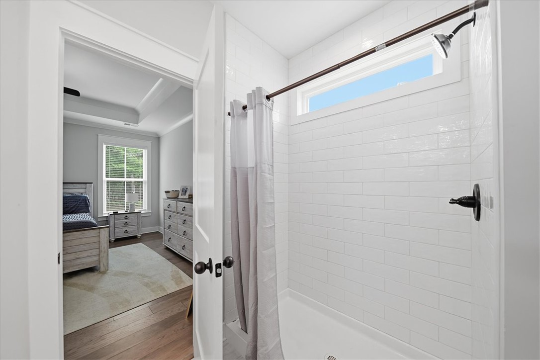214 Timothy Court Anderson, SC 29621 - Photo 29 of 43 A pristine shower stall, clad in white subway tiles, offers a bright and refreshing bathing experience.