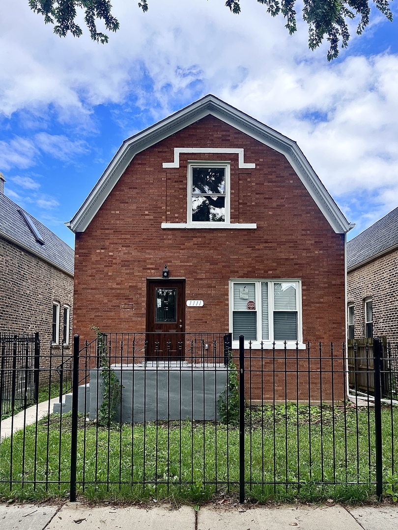 1111 North Keystone Avenue Chicago, IL 60651 - Photo 1 of 34 a front view of a house with a garden