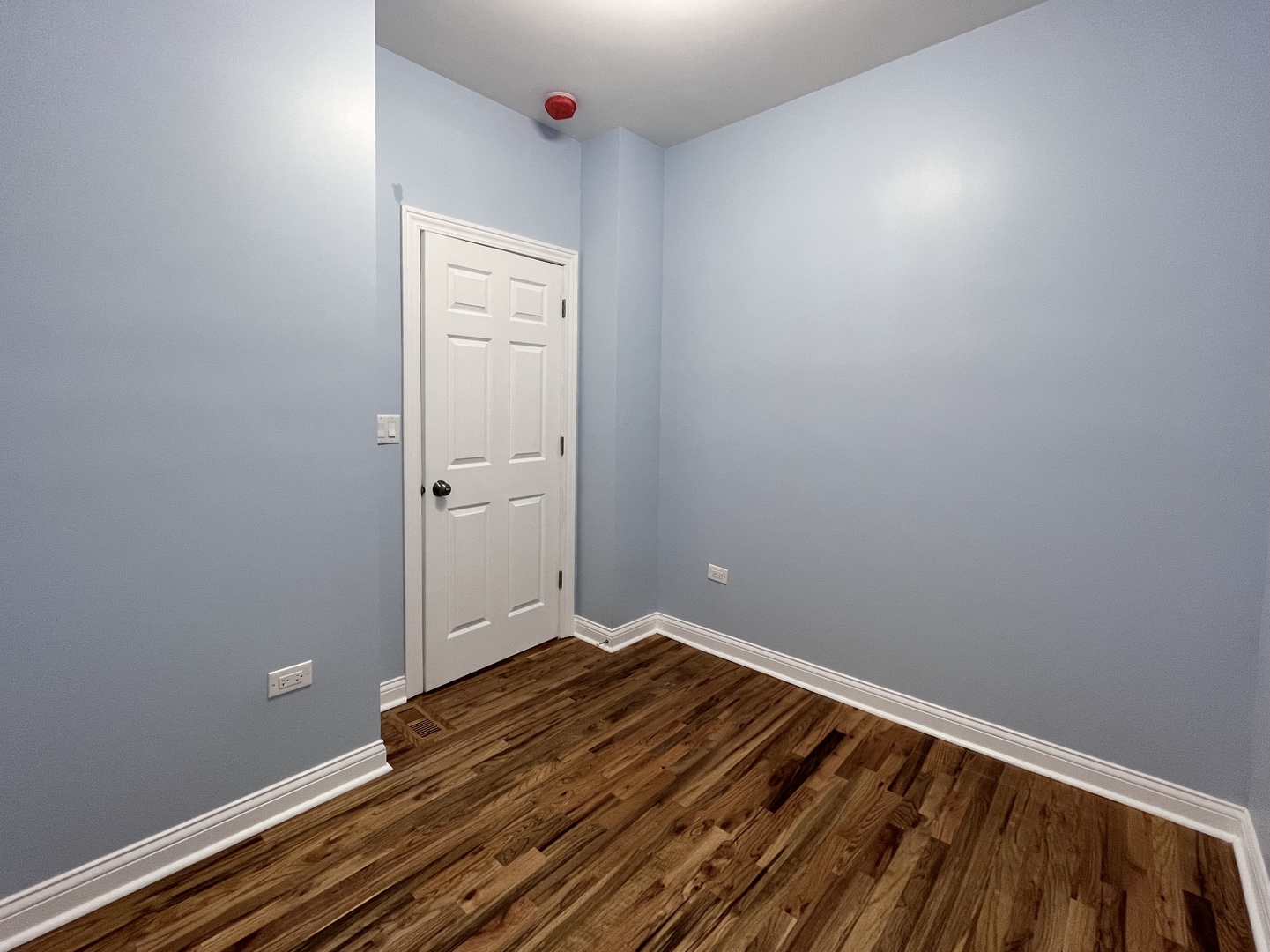 1111 North Keystone Avenue Chicago, IL 60651 - Photo 12 of 34 a view of a room with wooden floor and white walls