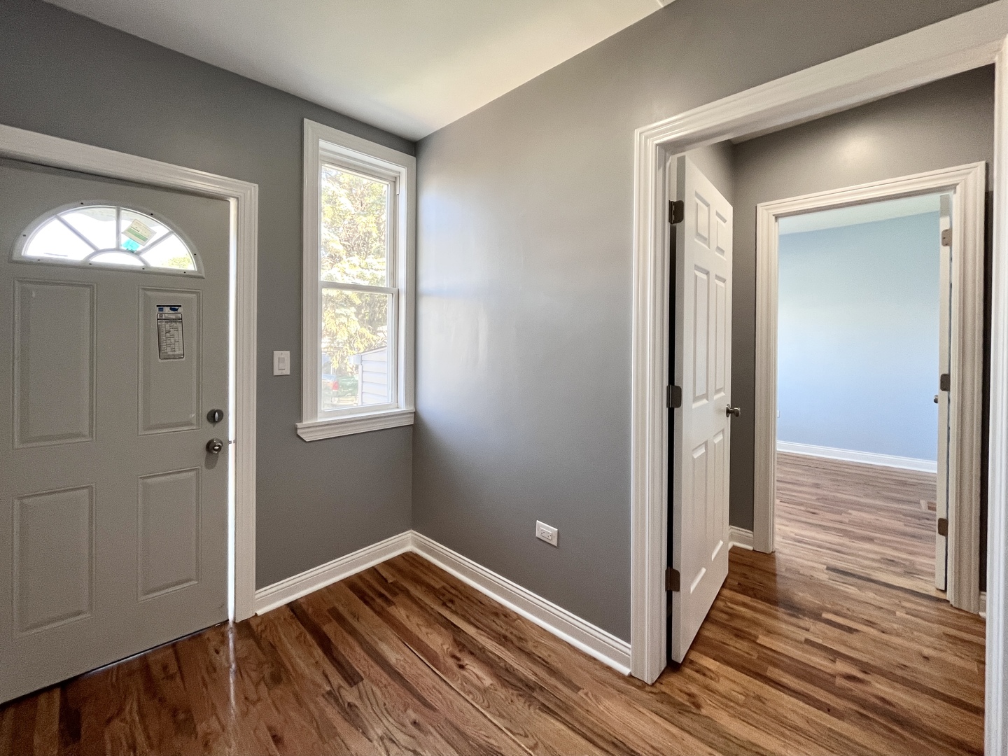 1111 North Keystone Avenue Chicago, IL 60651 - Photo 15 of 34 a view of hallway with window and wooden floor