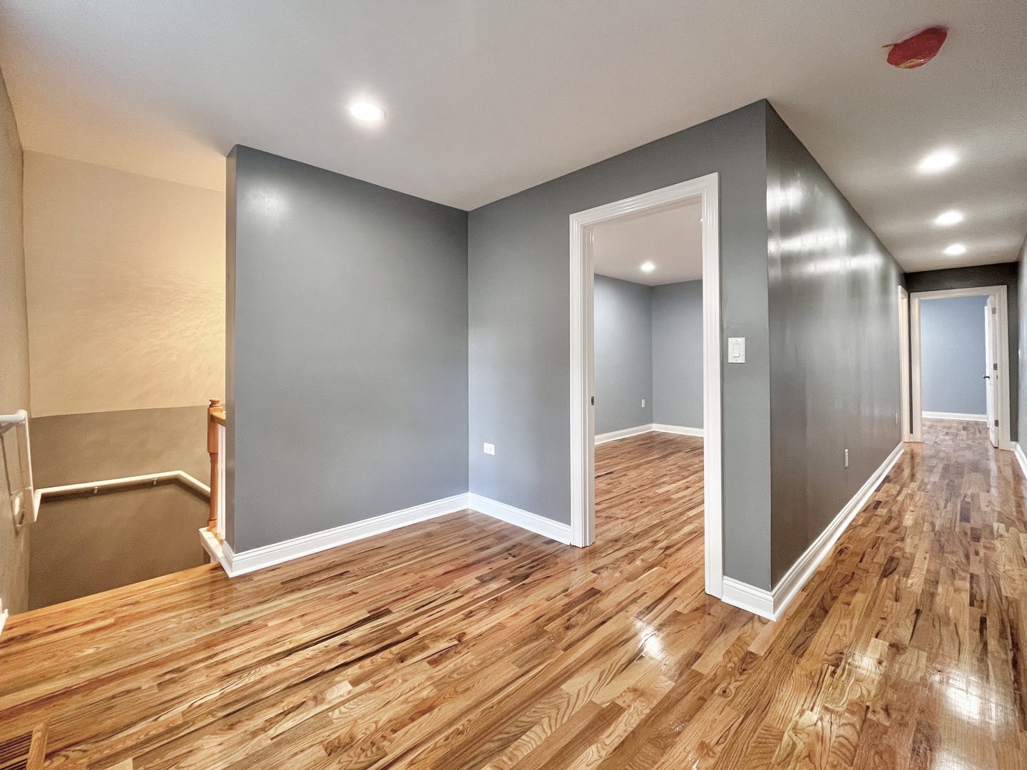 1111 North Keystone Avenue Chicago, IL 60651 - Photo 18 of 34 a view of hallway with stairs and wooden floor