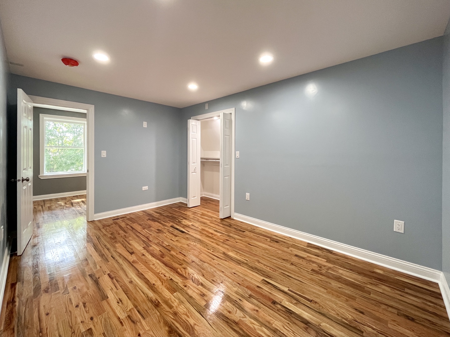 1111 North Keystone Avenue Chicago, IL 60651 - Photo 19 of 34 a view of an empty room with wooden floor and a window