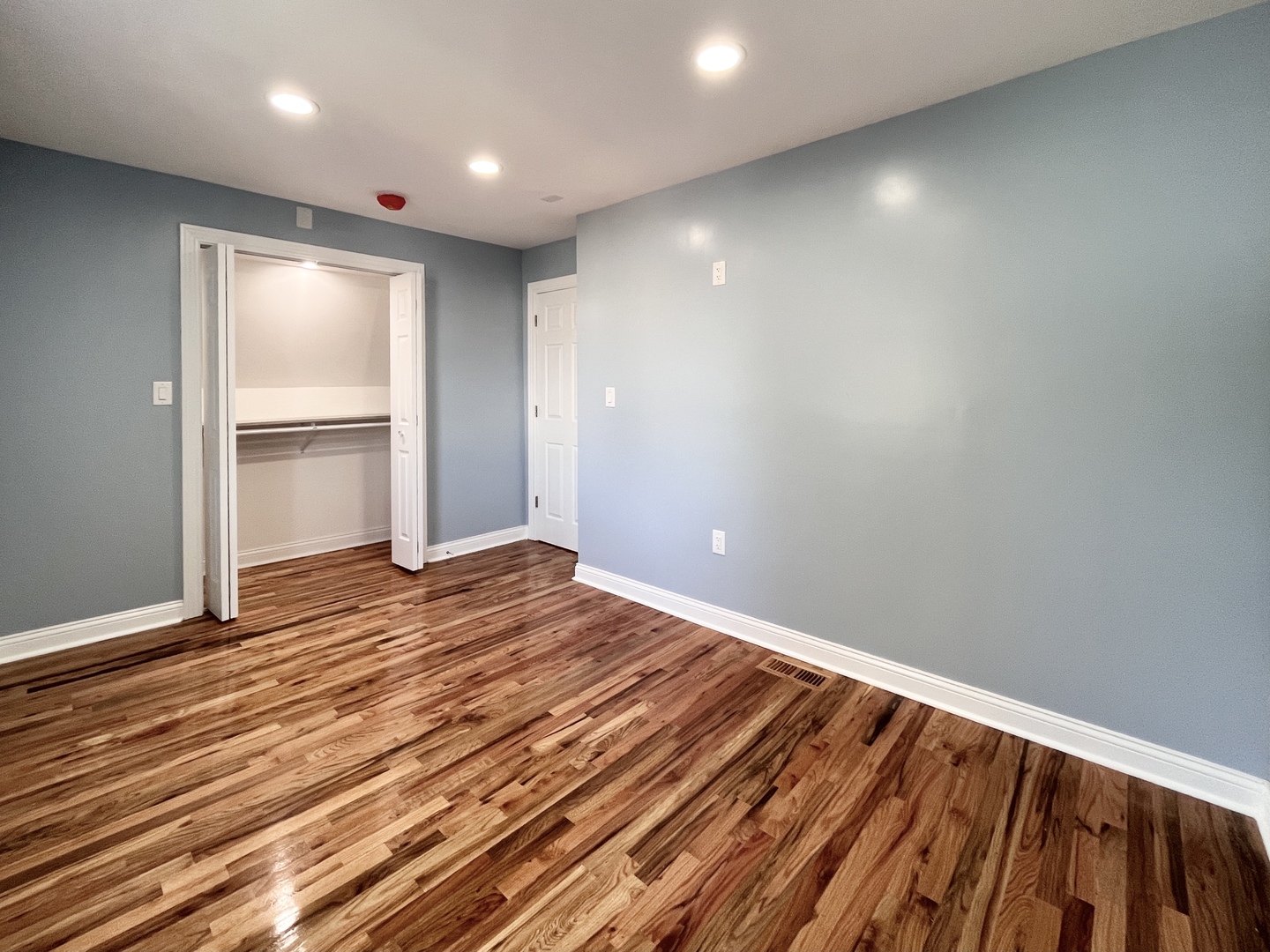 1111 North Keystone Avenue Chicago, IL 60651 - Photo 22 of 34 a view of an empty room with wooden floor and closet