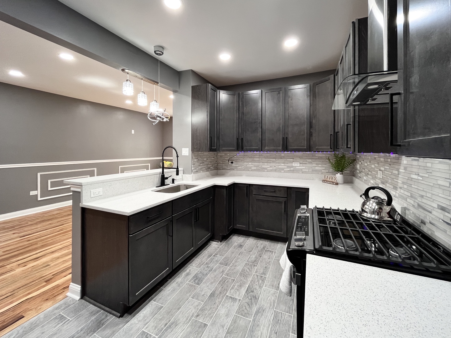 1111 North Keystone Avenue Chicago, IL 60651 - Photo 3 of 34 a kitchen with a sink appliances and cabinets