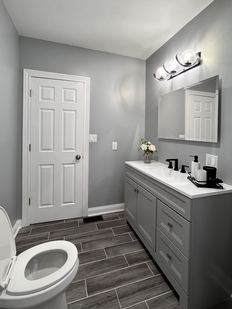 1111 North Keystone Avenue Chicago, IL 60651 - Photo 7 of 34 a bathroom with a sink and a mirror