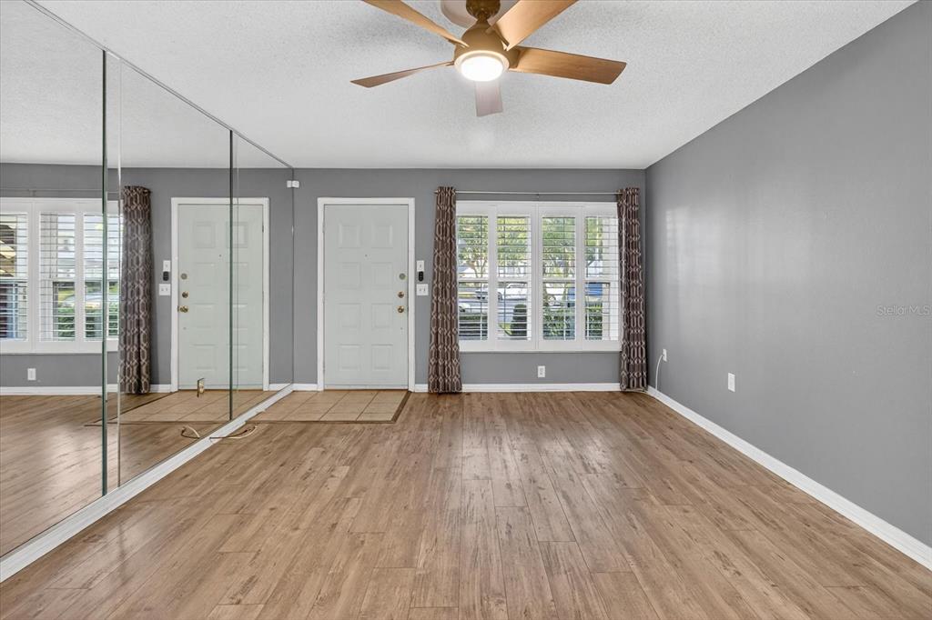 7802 Hardwick Drive, Unit 1116 New Port Richey, FL 34653 - Photo 14 of 73 a view of an empty room with a window and wooden floor