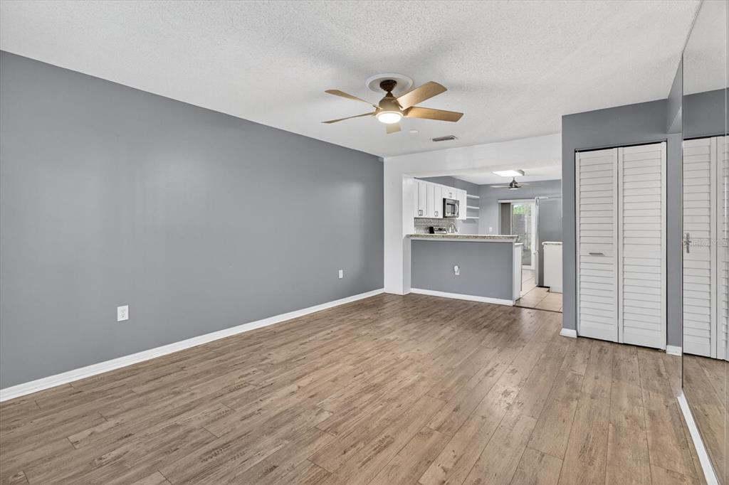 7802 Hardwick Drive, Unit 1116 New Port Richey, FL 34653 - Photo 17 of 73 a view of a kitchen with wooden floor and a ceiling fan
