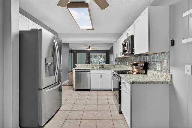 a view of a refrigerator in kitchen and stainless steel appliances