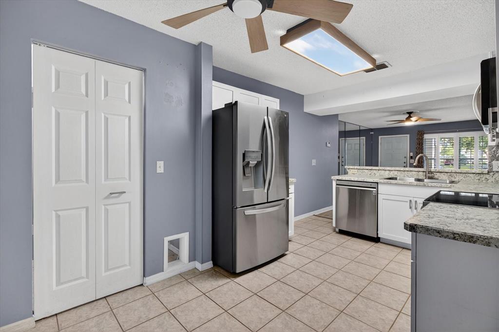 7802 Hardwick Drive, Unit 1116 New Port Richey, FL 34653 - Photo 22 of 73 a kitchen with stainless steel appliances granite countertop a refrigerator and a stove
