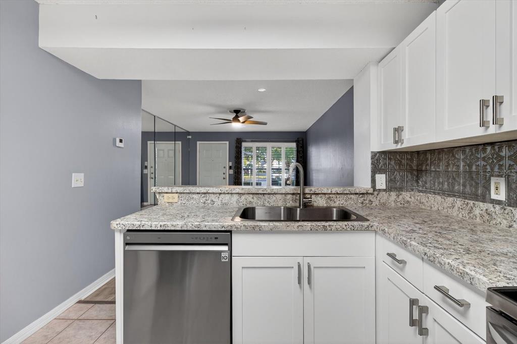 7802 Hardwick Drive, Unit 1116 New Port Richey, FL 34653 - Photo 26 of 73 a kitchen with cabinets appliances and a counter space