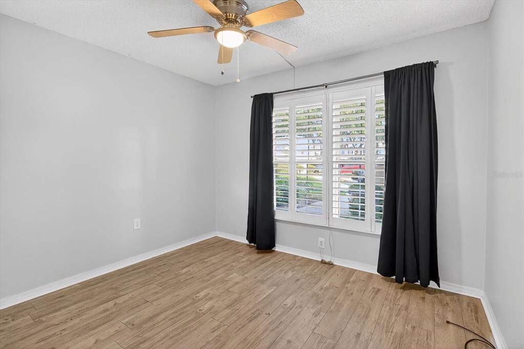 7802 Hardwick Drive, Unit 1116 New Port Richey, FL 34653 - Photo 31 of 73 a view of an empty room with a window and wooden floor