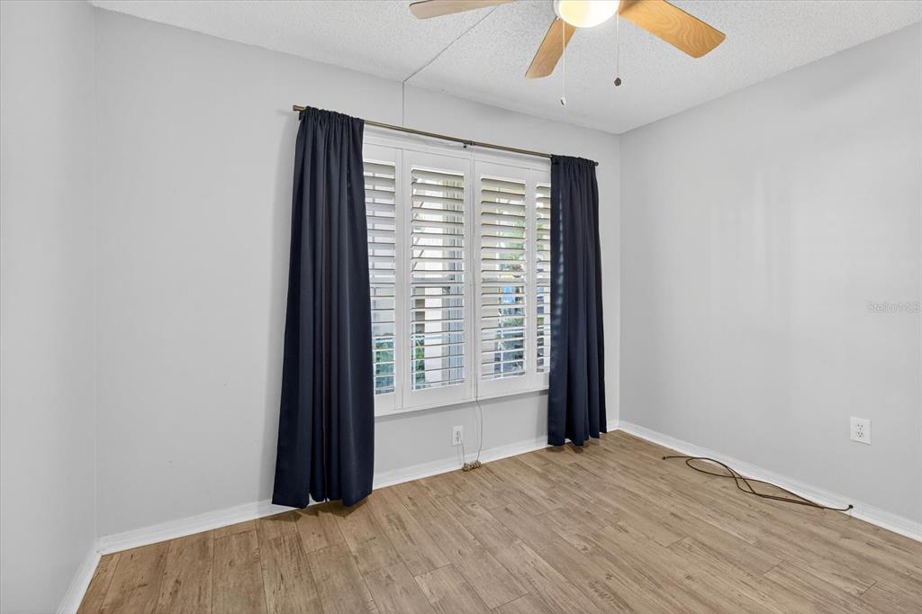 7802 Hardwick Drive, Unit 1116 New Port Richey, FL 34653 - Photo 32 of 73 an empty room with wooden floor and windows