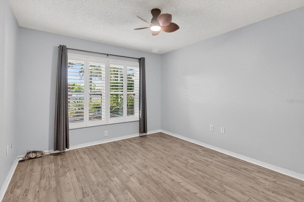 7802 Hardwick Drive, Unit 1116 New Port Richey, FL 34653 - Photo 37 of 73 a view of an empty room with a window and wooden floor
