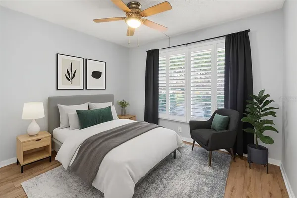 a bedroom with a bed and a large window