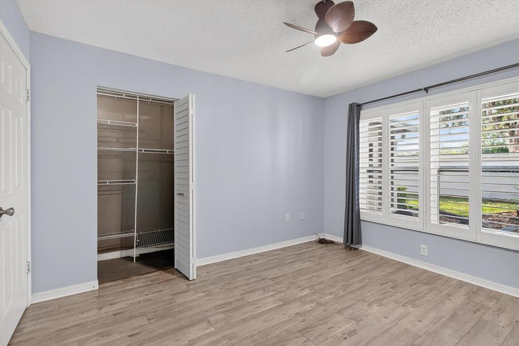7802 Hardwick Drive, Unit 1116 New Port Richey, FL 34653 - Photo 41 of 73 a view of an empty room with a window and wooden floor