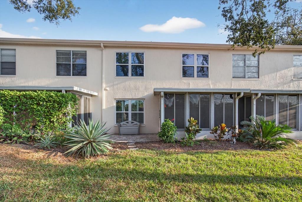 7802 Hardwick Drive, Unit 1116 New Port Richey, FL 34653 - Photo 47 of 73 a front view of a house with a yard and potted plants