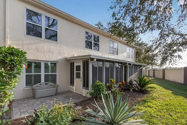 an aerial view of a house with swimming pool and a yard