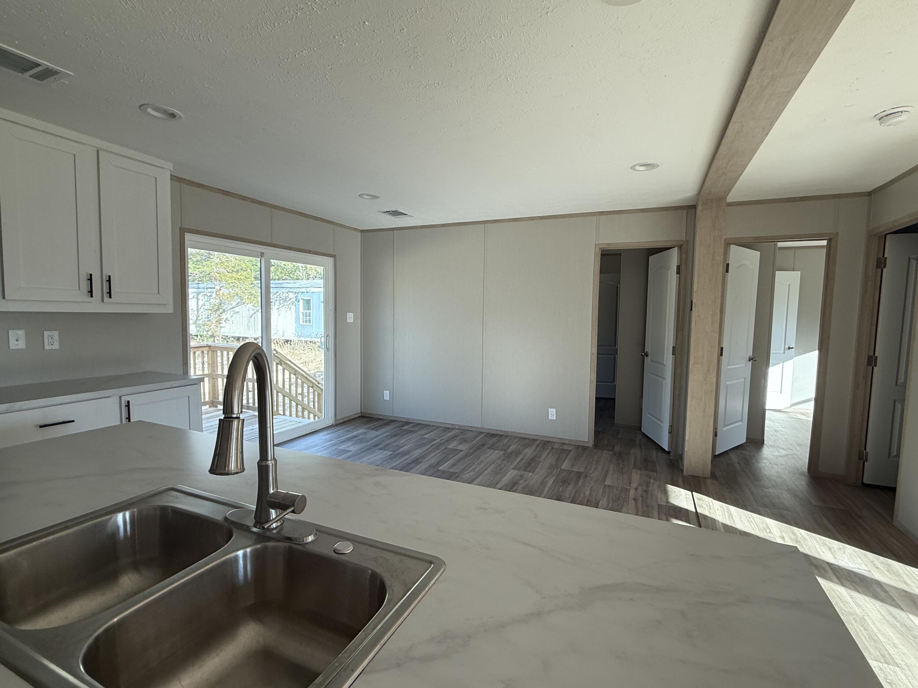 5264 3rd Avenue Crestview, FL 32539 - Photo 9 of 25 a kitchen with a sink and refrigerator