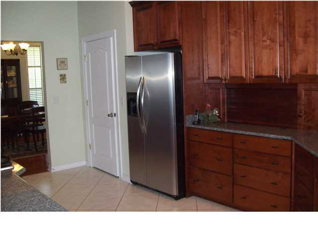 2572 Richardson Road Crestview, FL 32539 - Photo 8 of 24 a kitchen with a refrigerator and cabinets