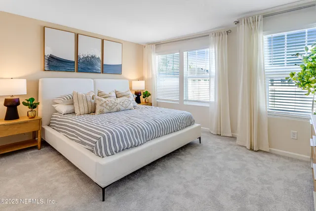 a bedroom with a bed and glass window