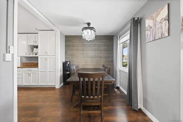 a view of a livingroom with kitchen and hardwood floor