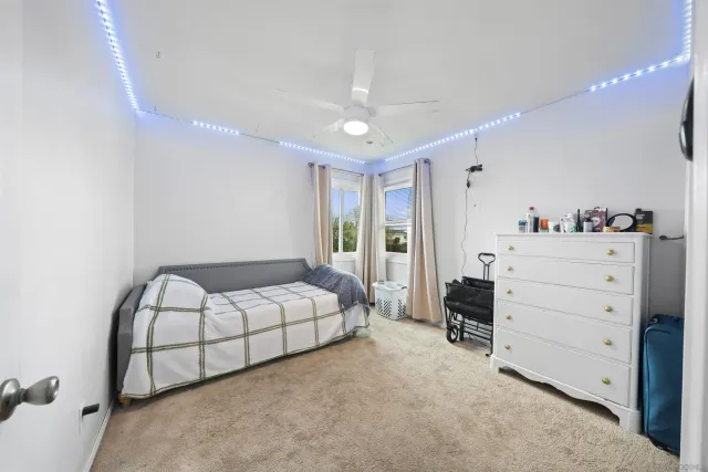 a spacious bedroom with a bed and a dresser