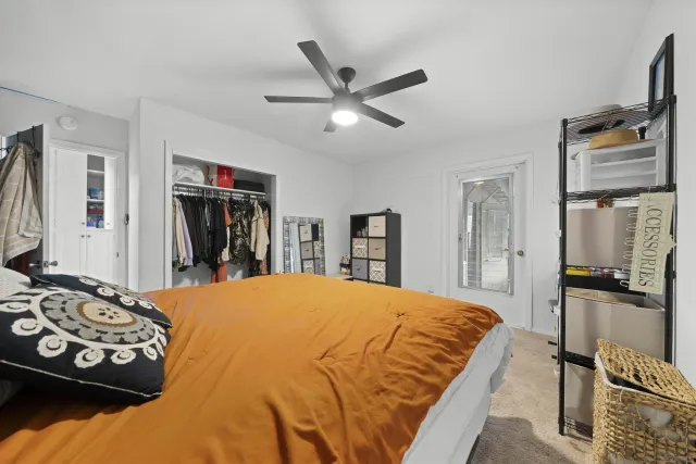 a bedroom with a bed and dresser with mirror