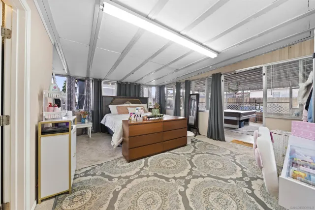 a bed room with a bed and a television