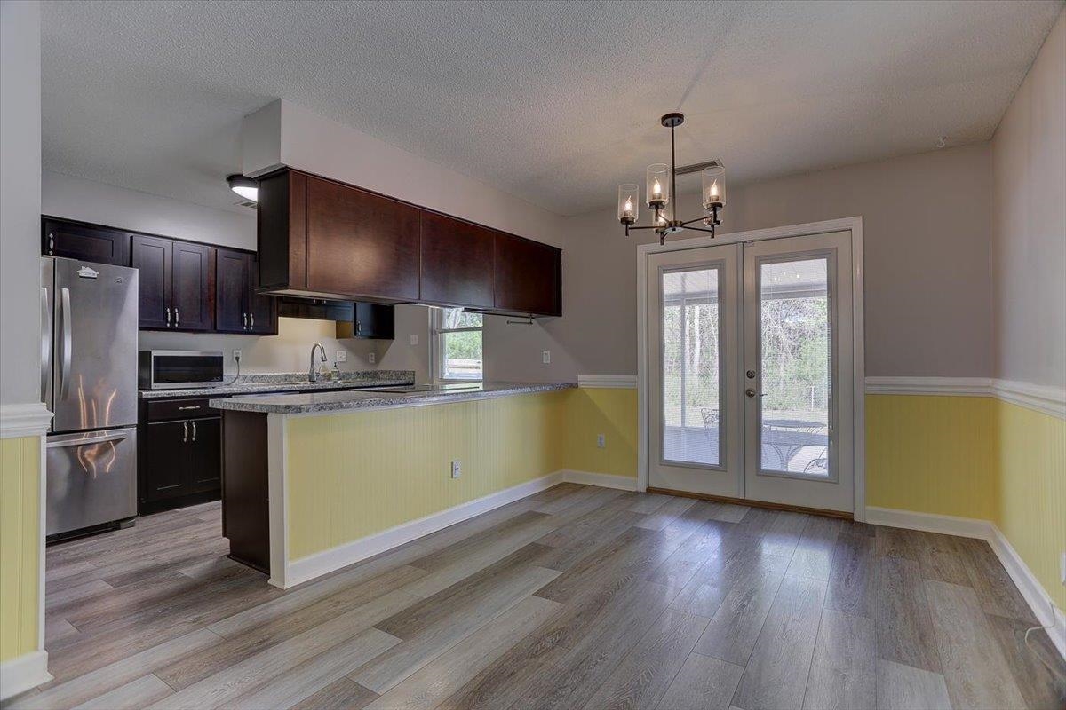 7304 Country Side Road Memphis, TN 38133 - Photo 6 of 18 Kitchen featuring a notable chandelier, light countertops, a sink, appliances with stainless steel finishes