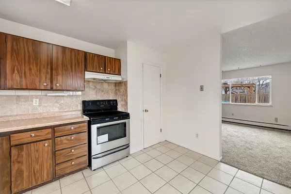 a kitchen with a sink stove and microwave
