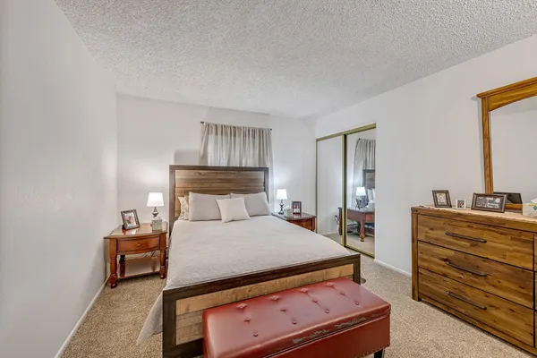 a bedroom with a bed and a table in it