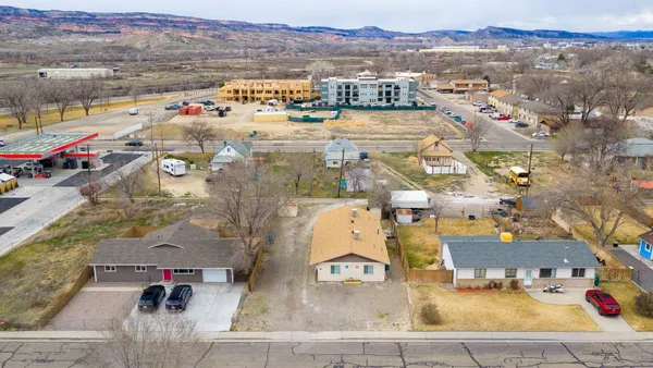 an aerial view of residential houses with outdoor space