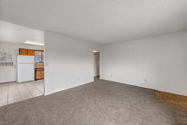 an empty room with a empty space and windows