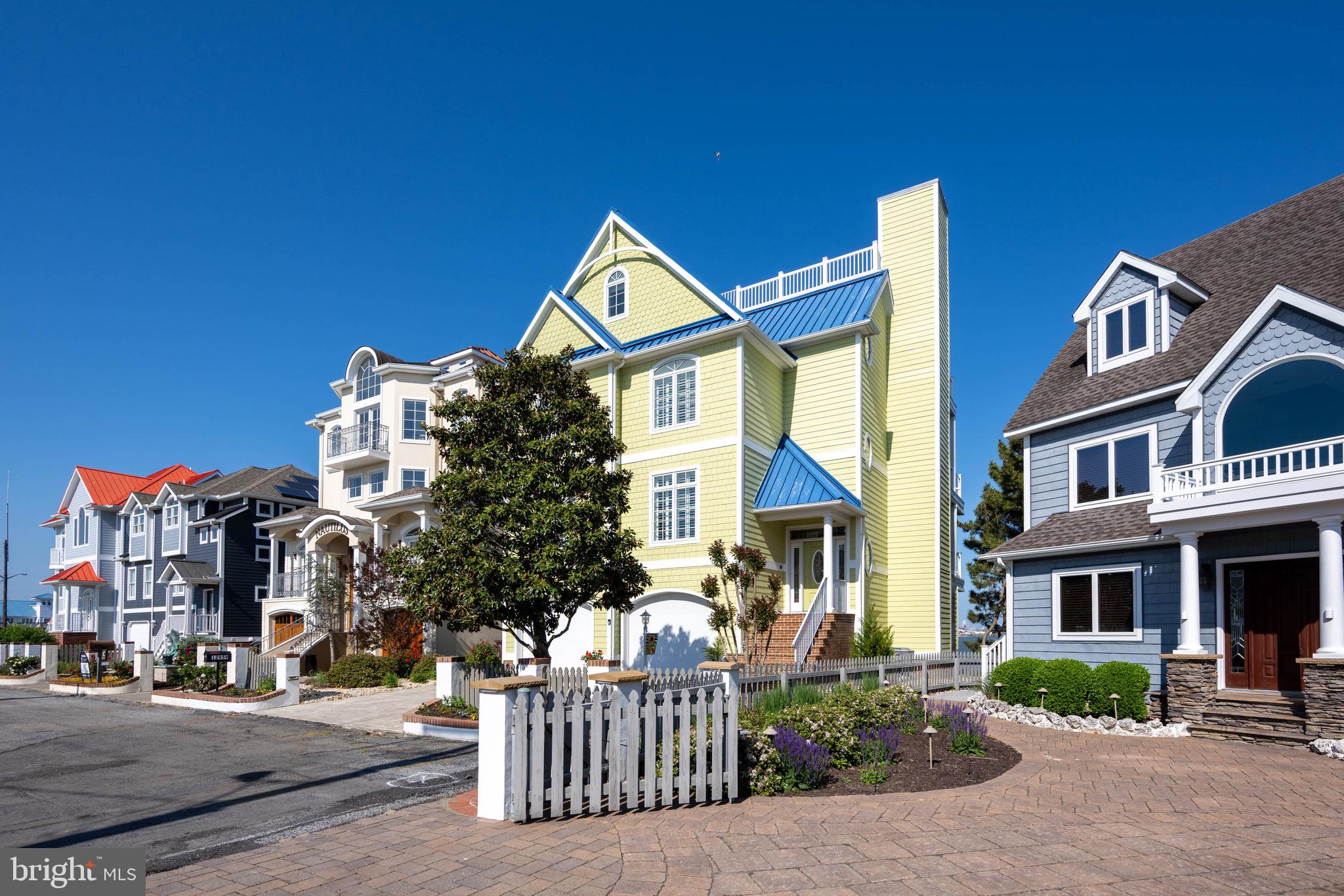 12959 Harbor Road Ocean City, MD 21842 - Photo 70 of 85 a front view of a residential apartment building with a yard