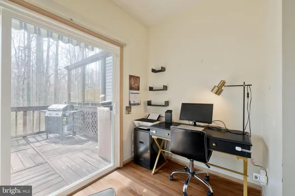 a view of a workspace with furniture and a window