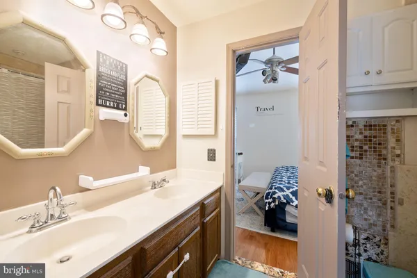 a bathroom with a sink double vanity and a mirror