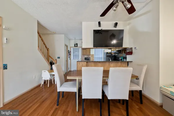 a dining room with furniture and wooden floor
