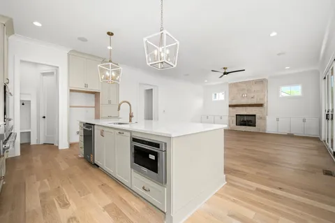 a bathroom with a sink toilet a mirror and shower