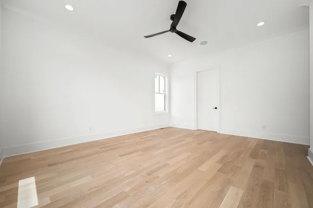 a view of walk in closet with empty racks