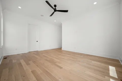 a view of a livingroom with a ceiling fan and window