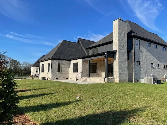 a view of an empty room with a fireplace and a large window