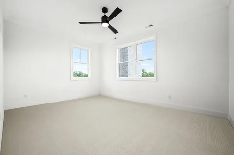 a view of a house with a yard and a large parking space