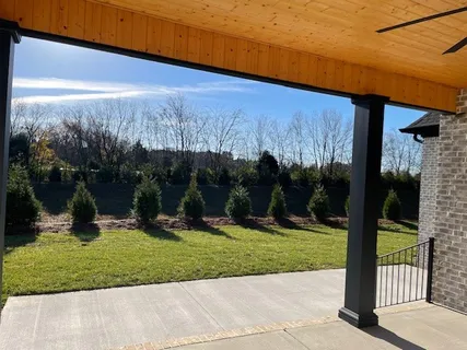 a view of a hallway with wooden floor and entryway