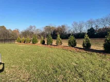 a kitchen with granite countertop white cabinets and stainless steel appliances