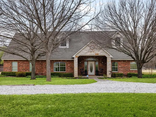 a front view of building with yard and green space