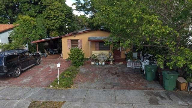 167 East 16th Street Hialeah, FL 33010 - Photo 2 of 4 a front view of a house with garden